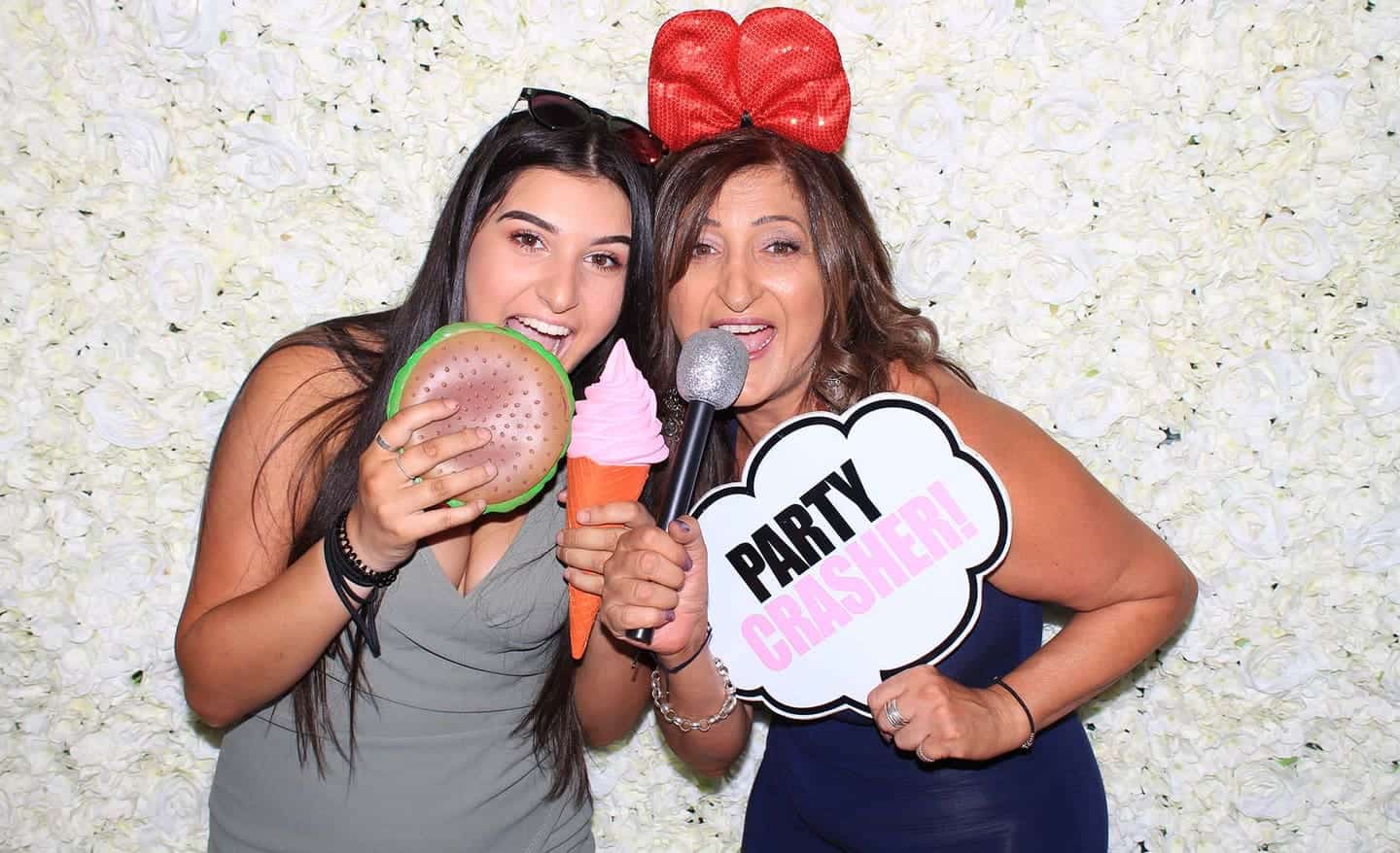 Guests posing in front of a flower wall