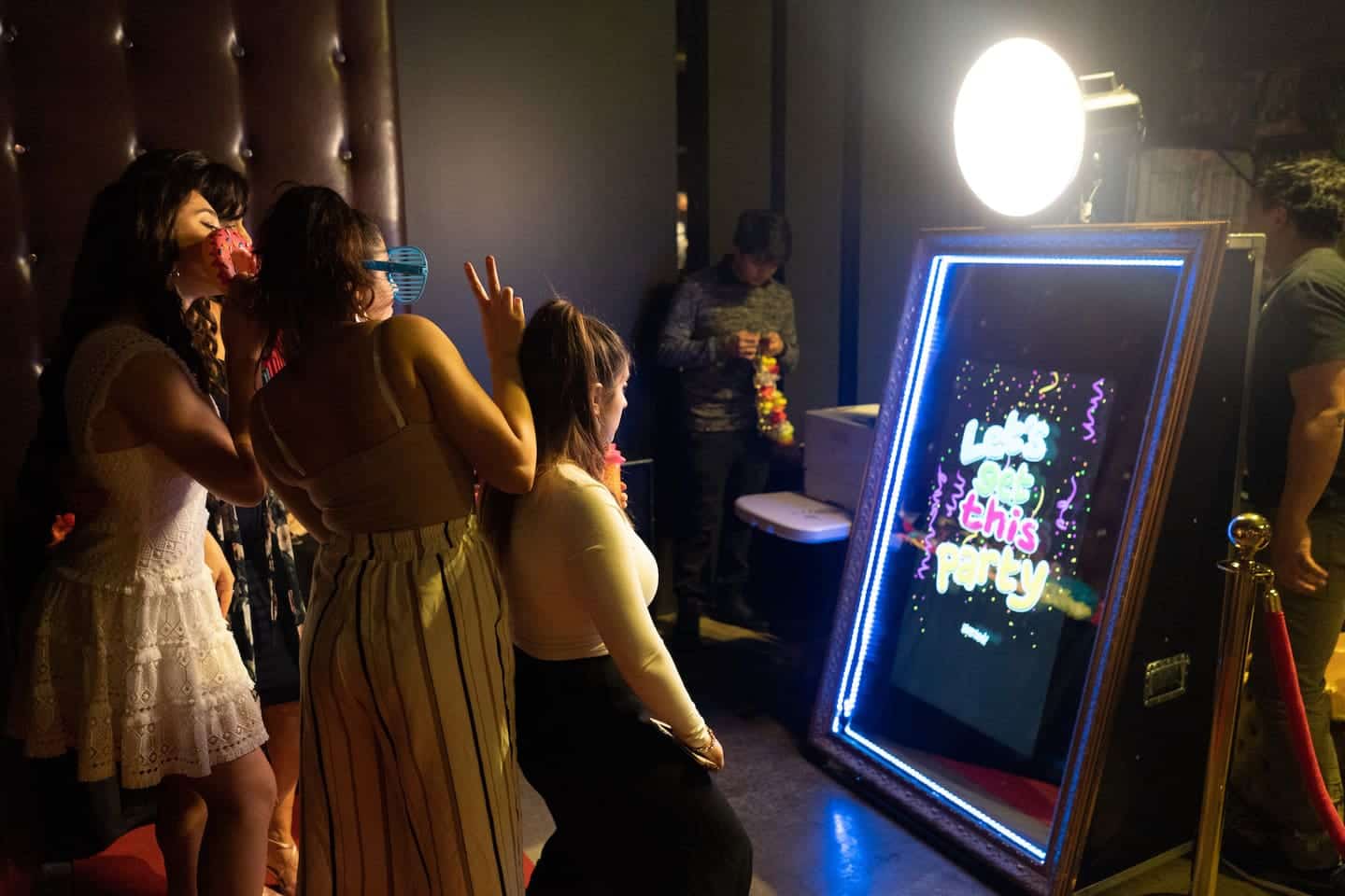 Guests at a mirror photo booth